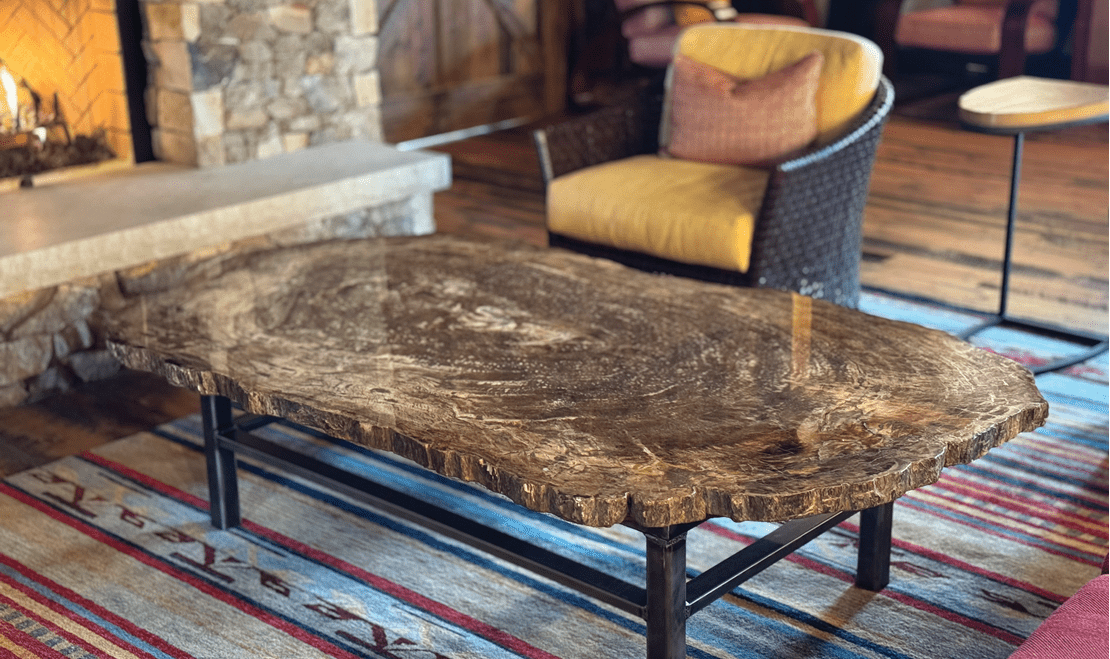 Within the barn sits a cozy fireplace featuring a beautiful wooden table resembling the reclaimed wood interior.