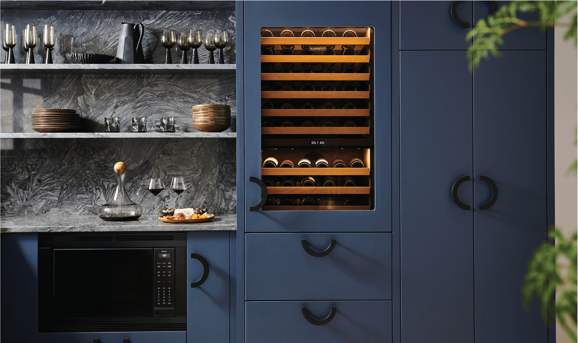 This Wolf Convection Microwave is hidden with black trim, right next to a Built-In Sub-Zero Wine Storage Unit.