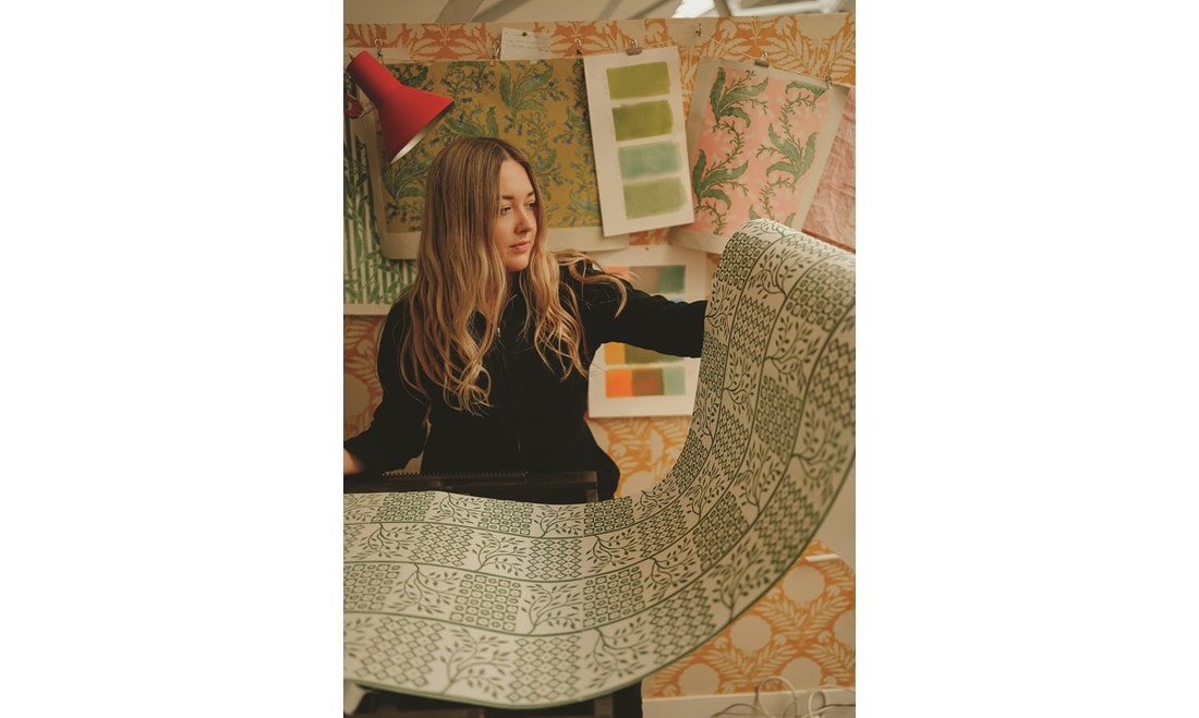 Merchant hand-inks her patterns for her fabrics and wallpapers