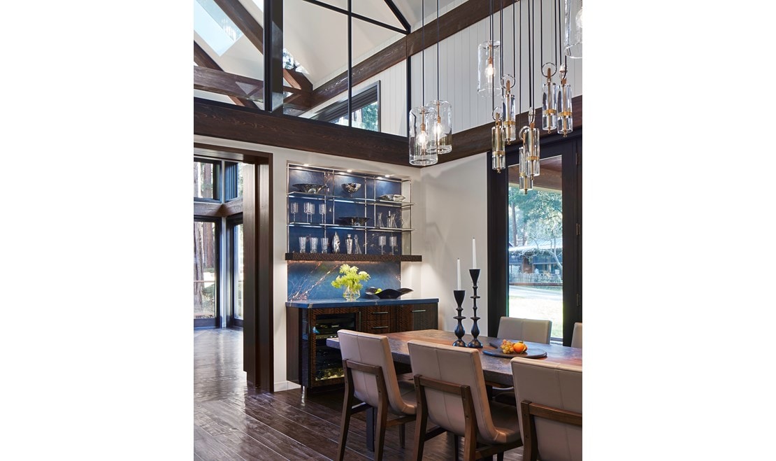 Sub-Zero Wine Storage blends perfectly with the dark hardwood brown floors, bright white walls, and stainless steel accents of this majestic Redwoods setting.