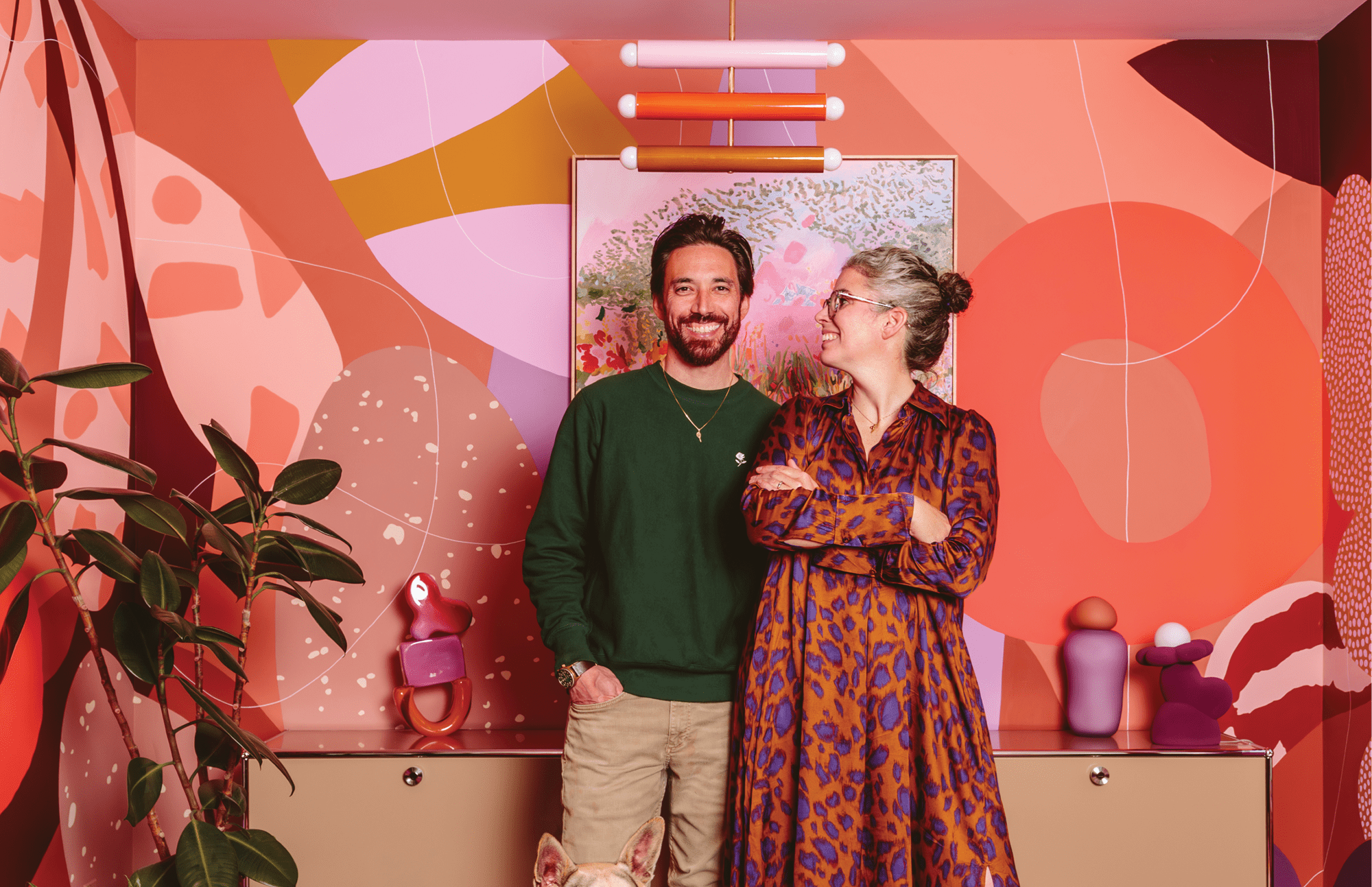 Artist Alex Proba, known for her colorful creations, pictured right, at home with her partner, Ian Coyle, pictured left.