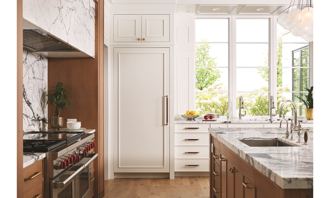 Sub-Zero refrigeration and freezer units are seamlessly integrated into an open kitchen design