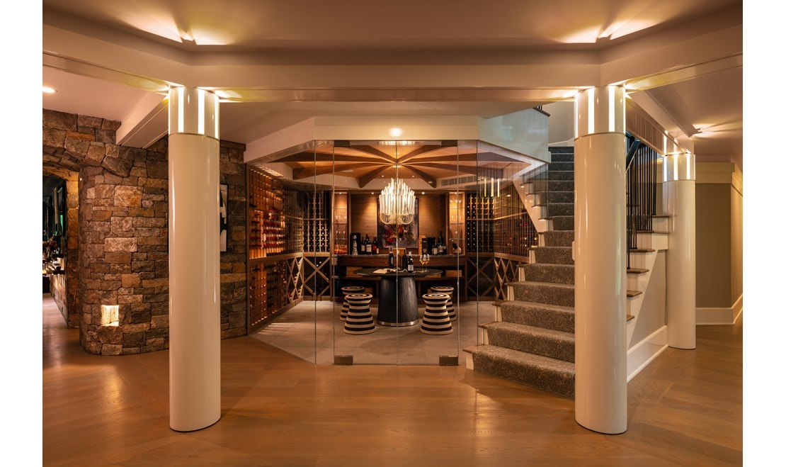 This sensational stone and glass-walled wine room reflects the overall architectural theme of the home. 
