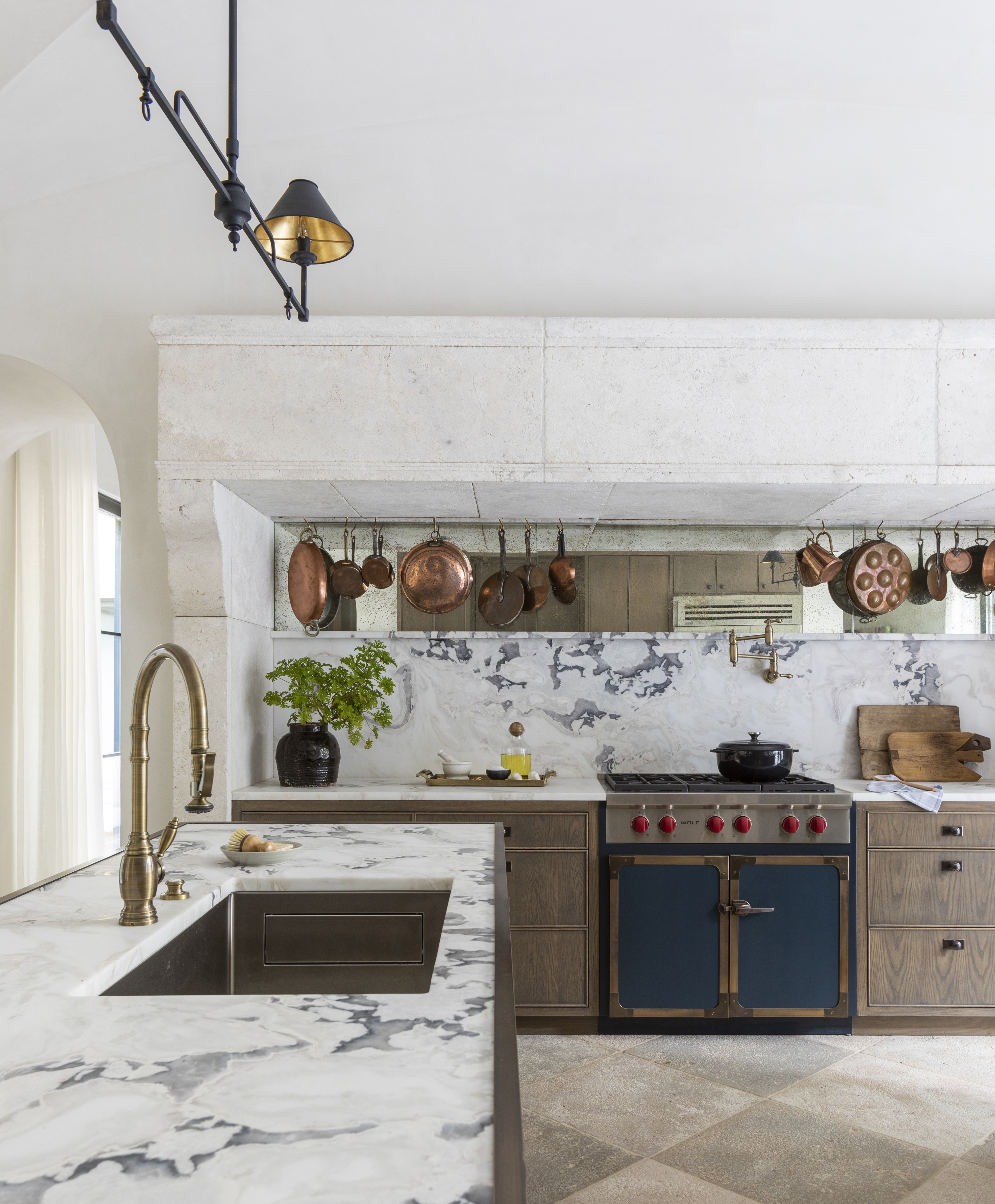 The Provençal kitchen design features a Sub-Zero refrigerator, a Wolf conventional and steam oven, and a coffee system.