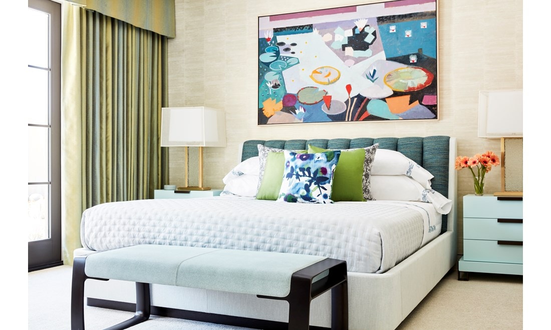 Primary bedroom suite leans into green, with hints of purple in the artwork and pillows that echo colors in the triptych in the loft