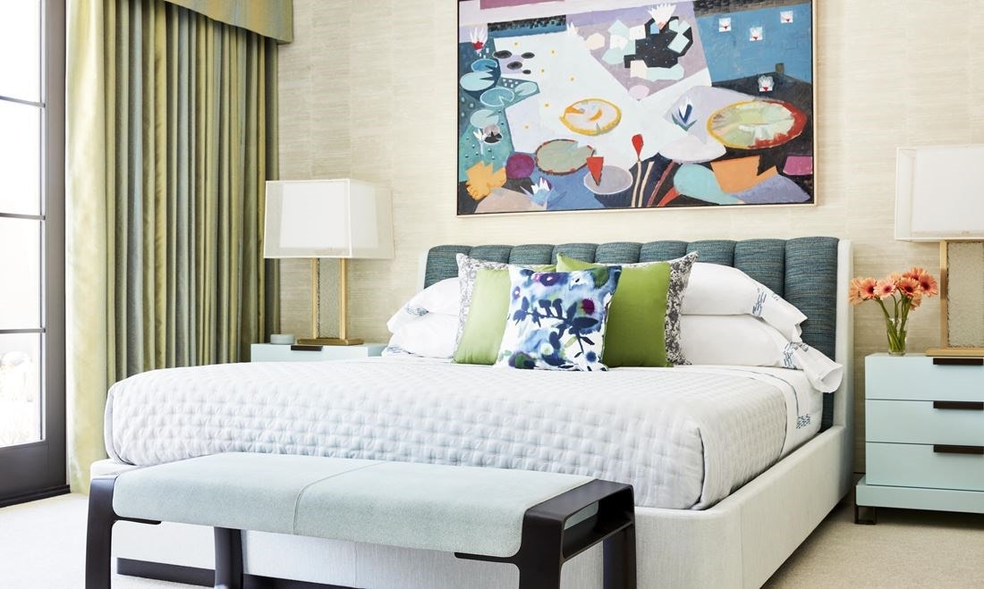 Primary bedroom suite leans into green, with hints of purple in the artwork and pillows that echo colors in the triptych in the loft