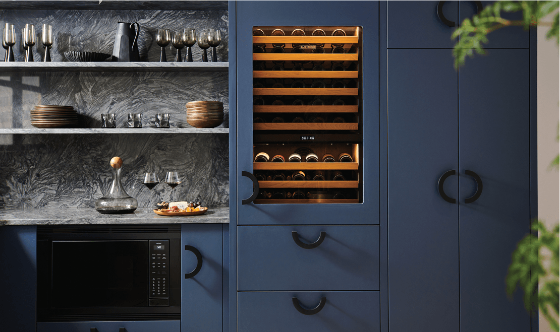 This Wolf Convection Microwave is hidden with black trim, right next to a Built-In Sub-Zero Wine Storage Unit.