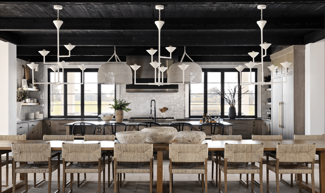 Paranjape's team can plan for simple or extravagant lighting fixtures, like this open-plan kitchen and dining room.