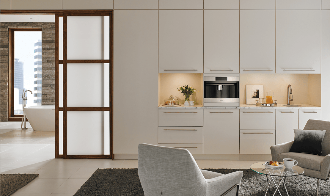 The Wolf Built-In 24-inch Coffee System fits seamlessly in this minimalist home featuring a Wolf 30-inch Warming Drawer.