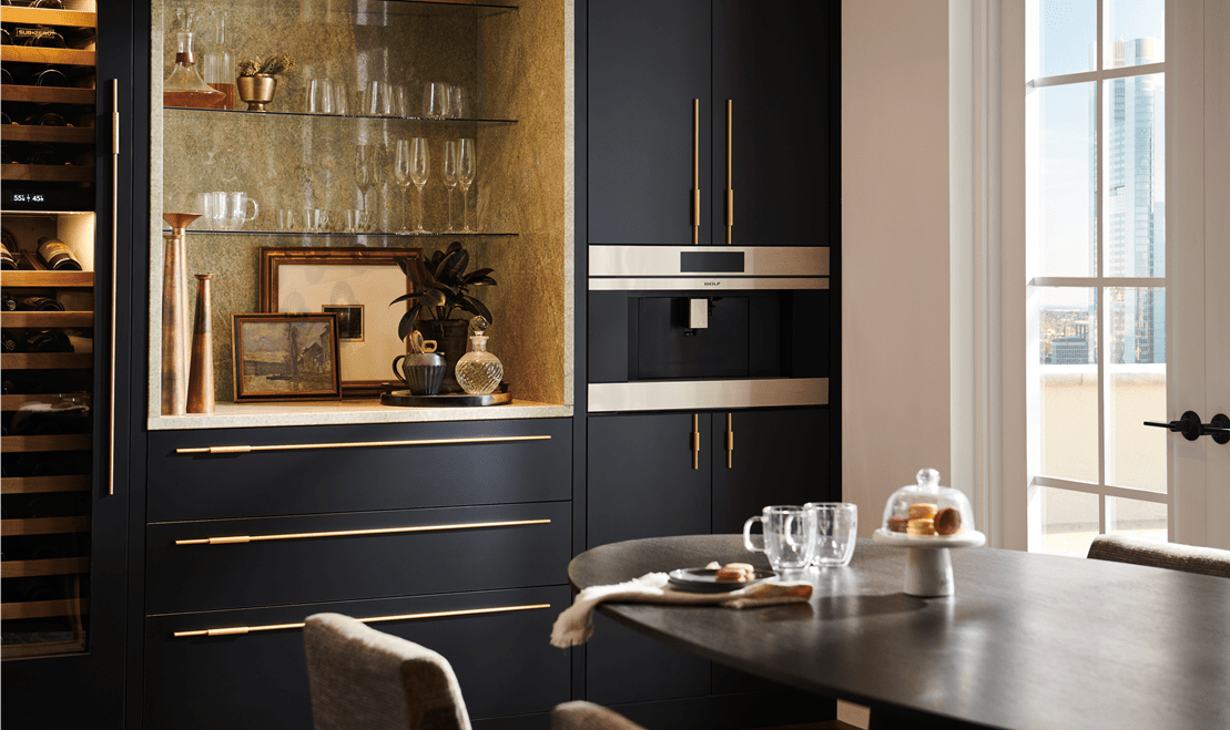 In this penthouse's dining room, a 30-inch M Series Coffee System can be seen next to a Sub-Zero Designer Wine Refrigerator.