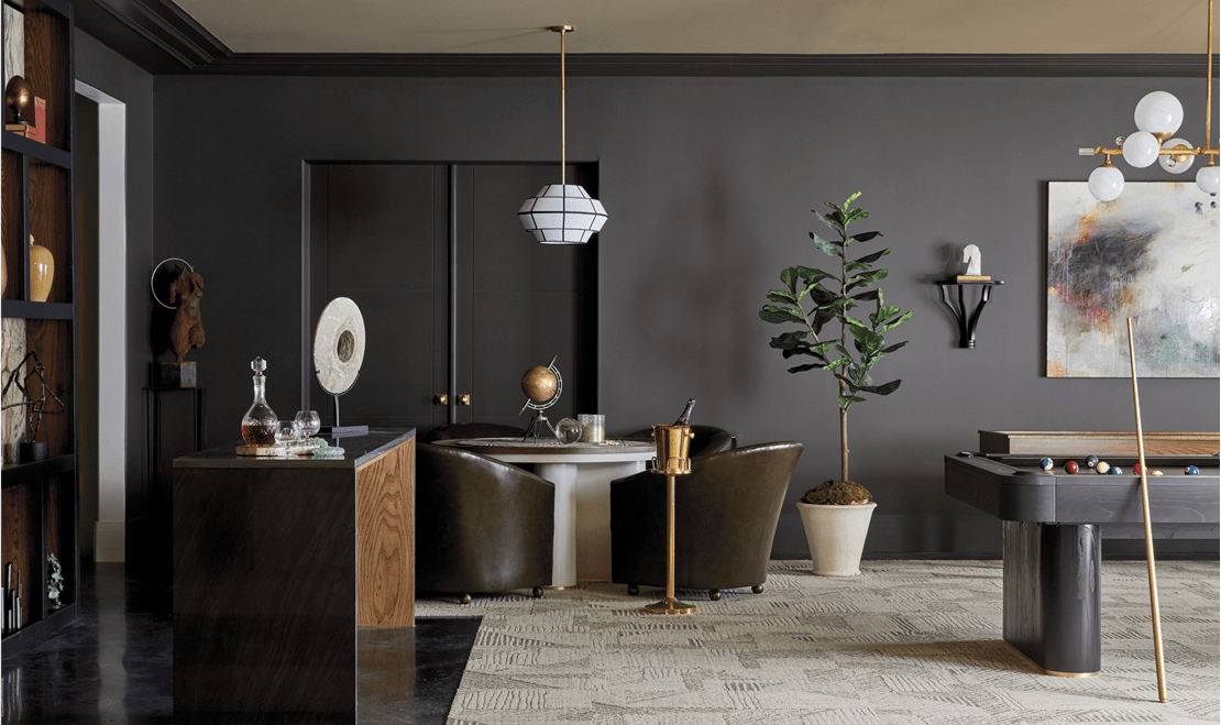 A quiet, dark game room featuring a billiards table by Valerie Garrett with Milie, Valerie Garrett Interiors.