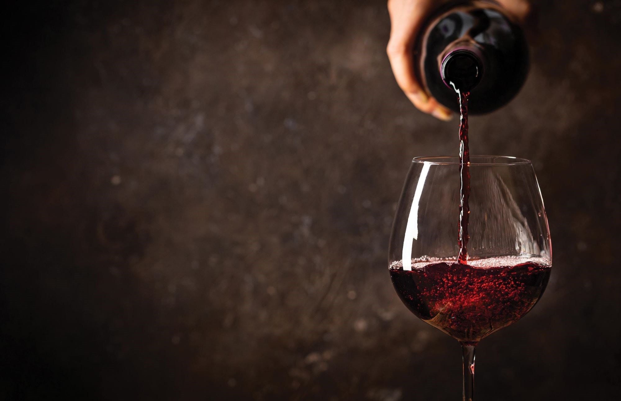 A cavern-like wine cellar for storage and celebration is the centerpiece of a New England home.