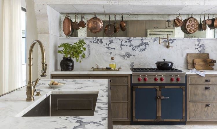 The Provençal kitchen design features a Sub-Zero refrigerator, a Wolf conventional and steam oven, and a coffee system.