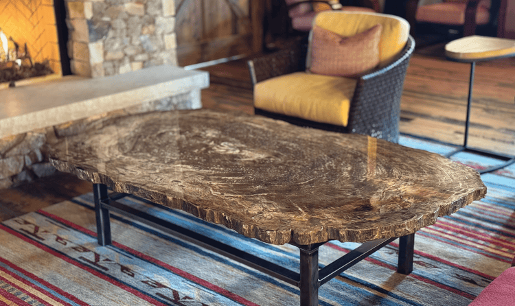 Within the barn sits a cozy fireplace featuring a beautiful wooden table resembling the reclaimed wood interior.