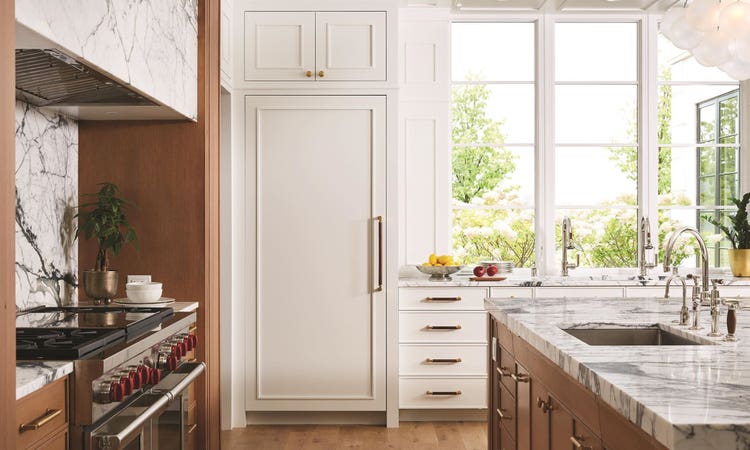 Sub-Zero refrigeration and freezer units are seamlessly integrated into an open kitchen design