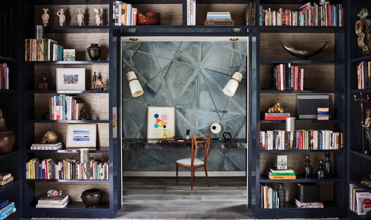 A custom interior collaboration with Jeffers Design Group highlighting an exceptional workspace hidden within shelves.