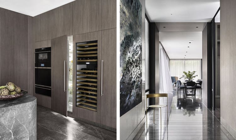 Timber wall houses four integrated columns of Sub-Zero refrigeration, including a wine storage unit along with a 30-inch-wide stack of sleek, black glass Wolf ovens—convection steam oven, single oven, and warming drawer