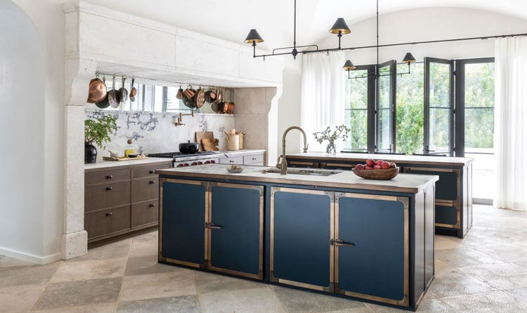 The kitchen combines simplicity and detailing, while double island hoods anchor the space.