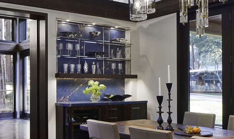 Sub-Zero Wine Storage blends perfectly with the dark hardwood brown floors, bright white walls, and stainless steel accents of this majestic Redwoods setting.