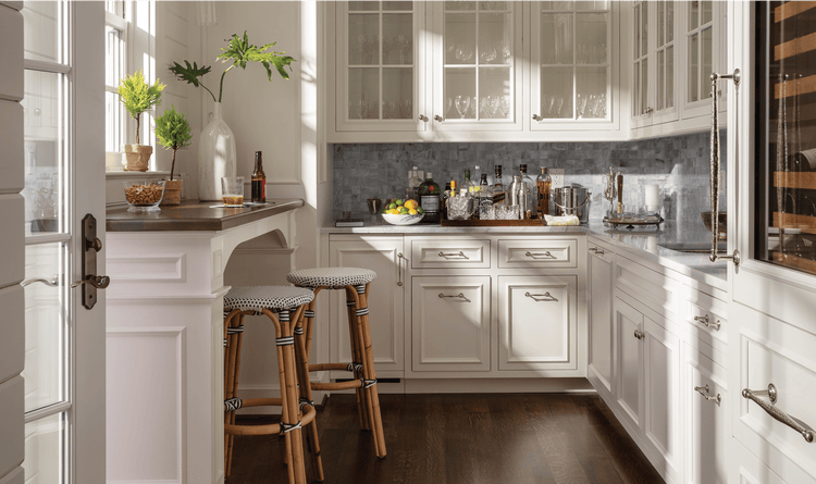 A butler's pantry can be accessed from outside. Inside is a Sub-Zero Wine Storage unit and a Sub-Zero icemaker.