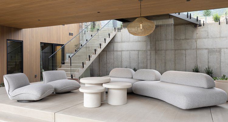 The space below the walkway features a couch with two chairs and many individual tables perfect for any outdoor gatherings.