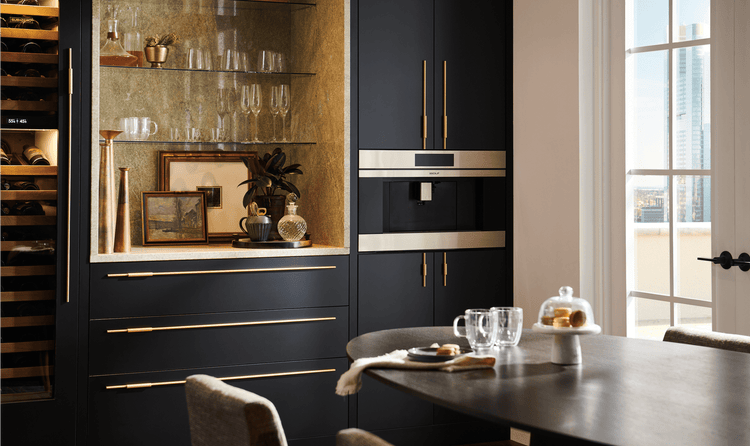 In this penthouse's dining room, a 30-inch M Series Coffee System can be seen next to a Sub-Zero Designer Wine Refrigerator.