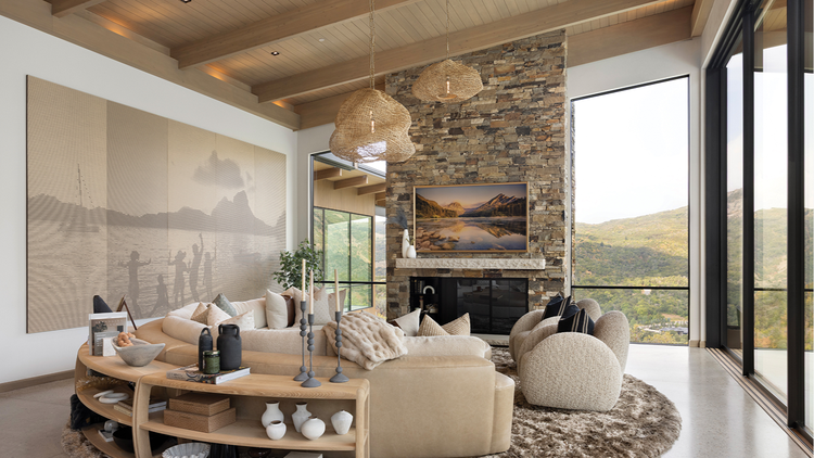The main living space features a large painting on the brick, fireplace mantle and the wall, with many seating options.