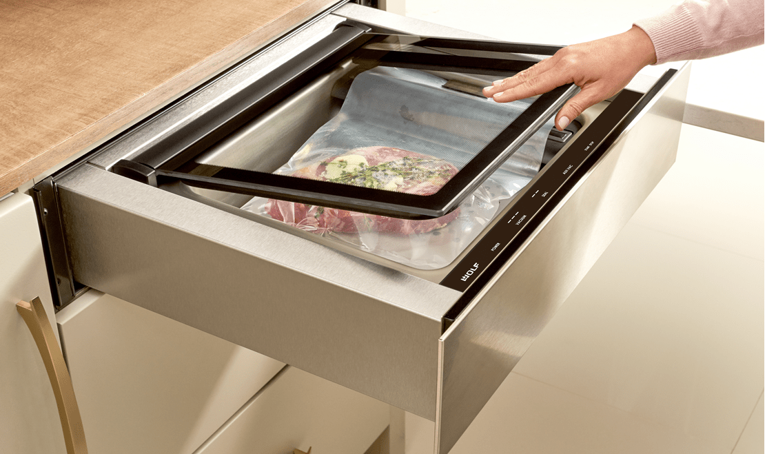 Glazed teriyaki infused rib of beef being prepped to be placed within a Wolf Vacuum Seal Drawer