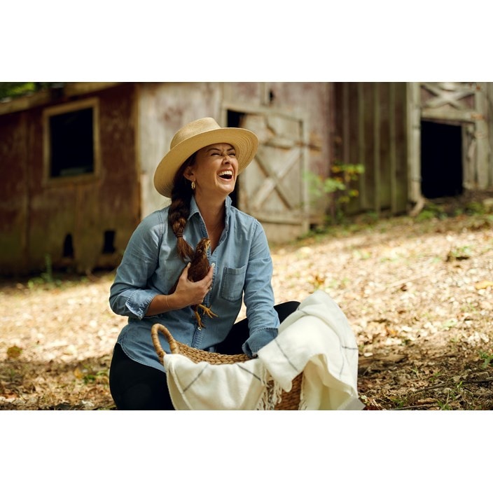 Chef Brandie cuddles one of her chickens on her farm in Central Tennessee