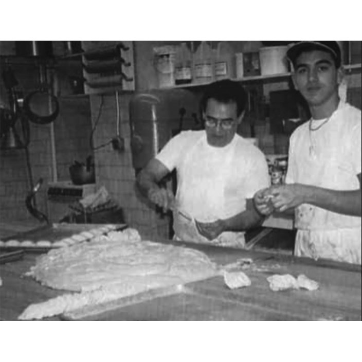 A young Valastro and his father working together at Carlo's Bakery. 