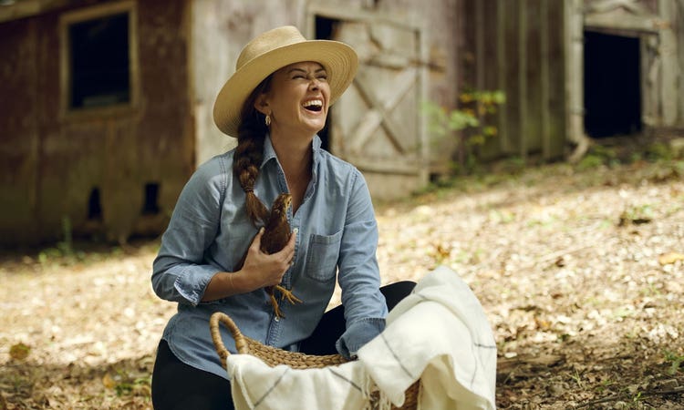 Chef Brandie cuddles one of her chickens on her farm in Central Tennessee