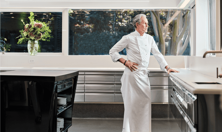 The kitchen of The French Laundry, designed to let in light from multiple windows, as Chef Keller poses contemplatively.