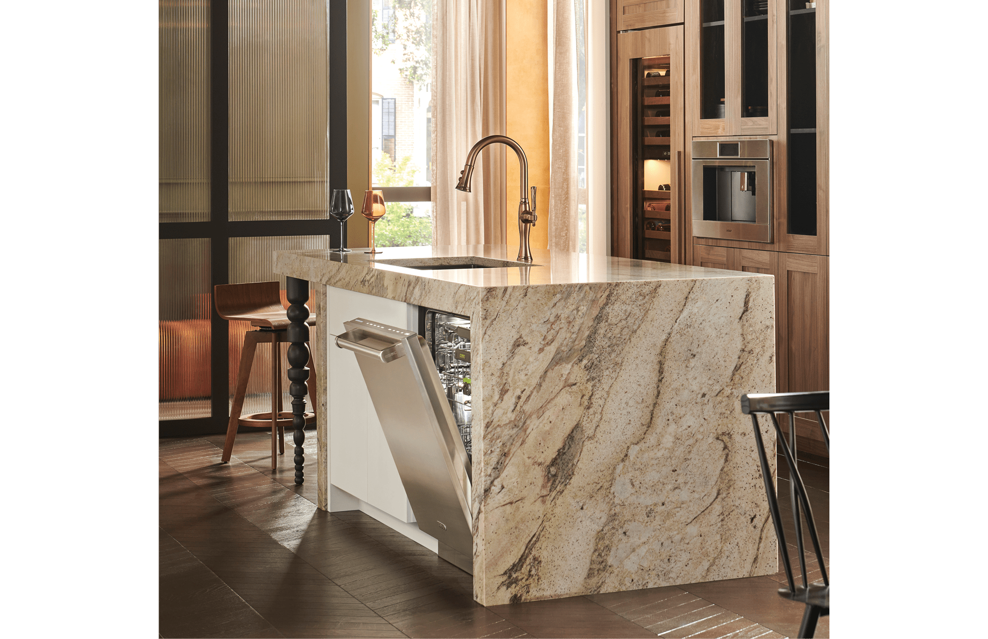 A built-in, Cove stainless-steel dishwasher opened slightly, allowing the empty interior to be shown.