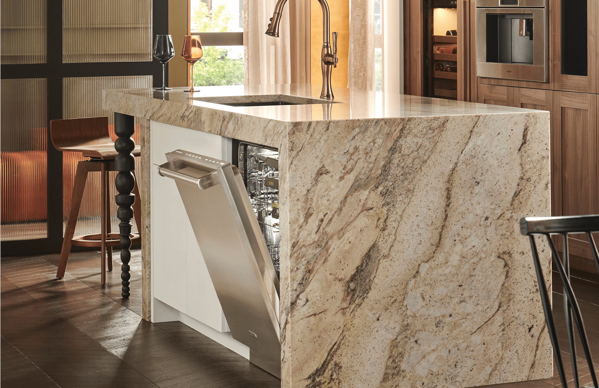 A built-in, Cove stainless-steel dishwasher opened slightly, allowing the empty interior to be shown.