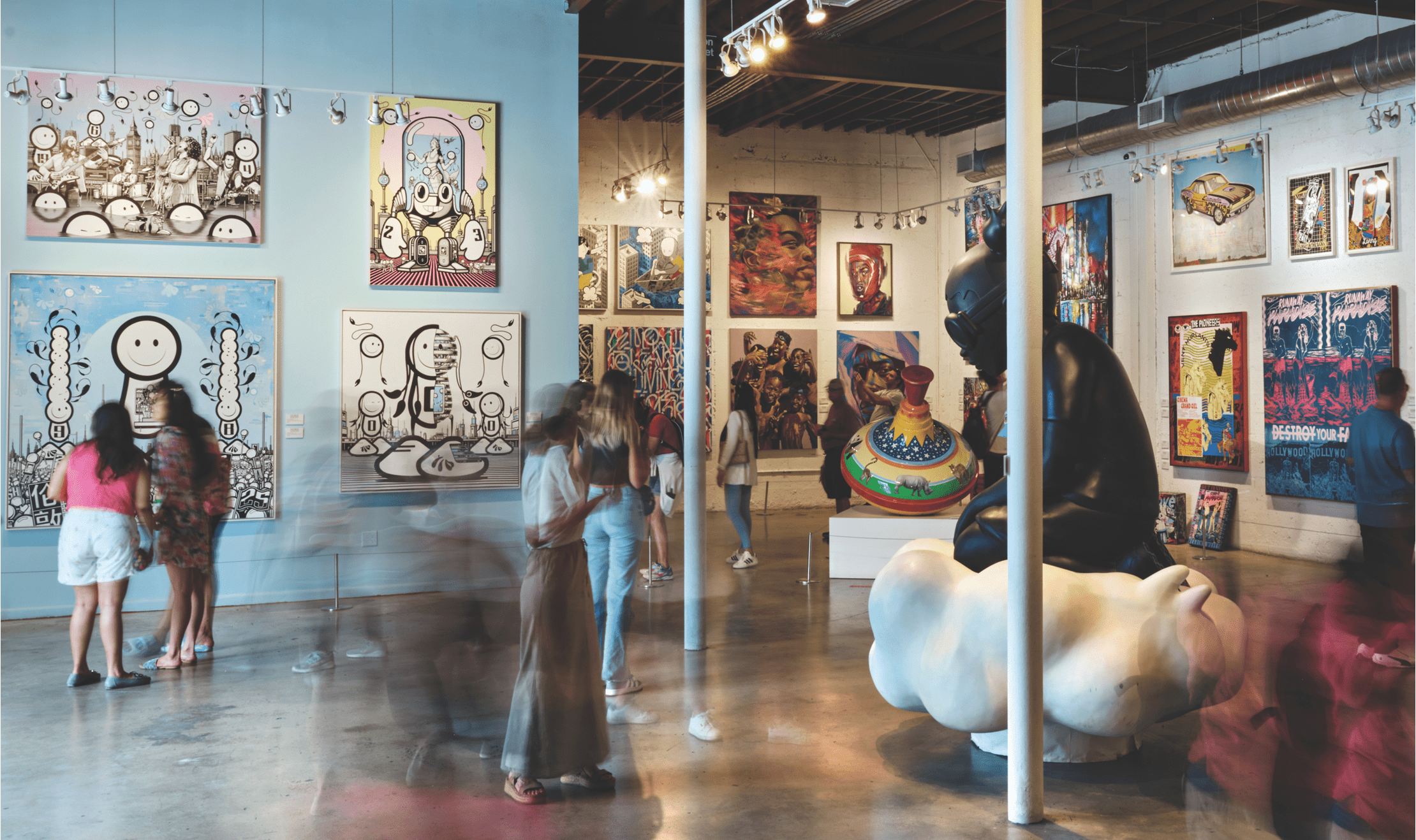 A room filled with   urban art on coutless canvases.