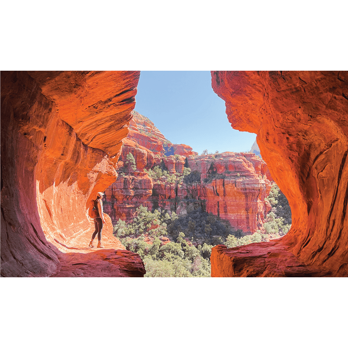 Sedona, Arizona is considered to be an energy cortex as people, like this climber, visit to see its well-known red cliffs.