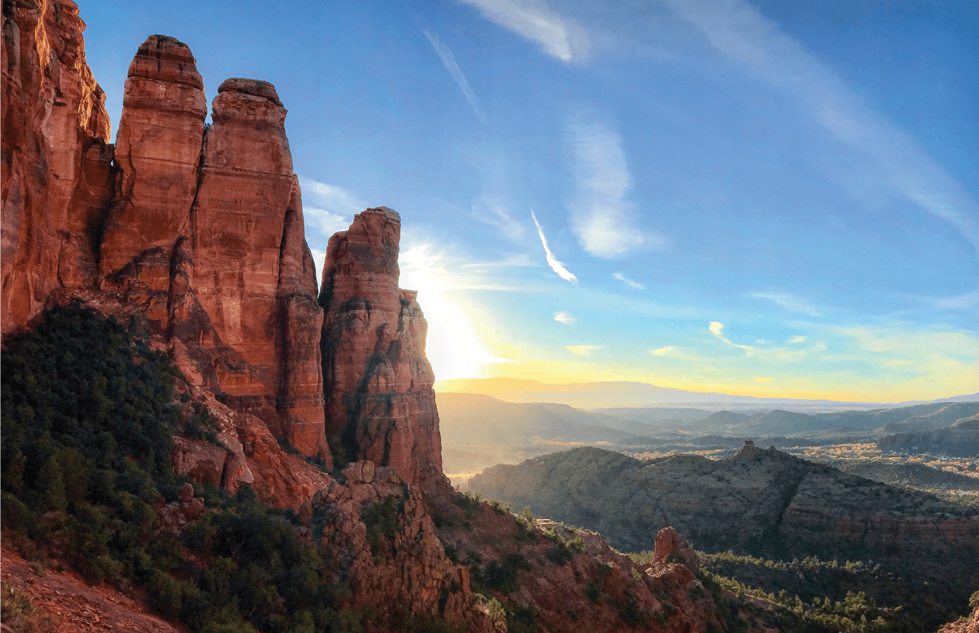 Energy vortexes can be found throughout the world, like this energetic sunrise behind a cascading rock formation.