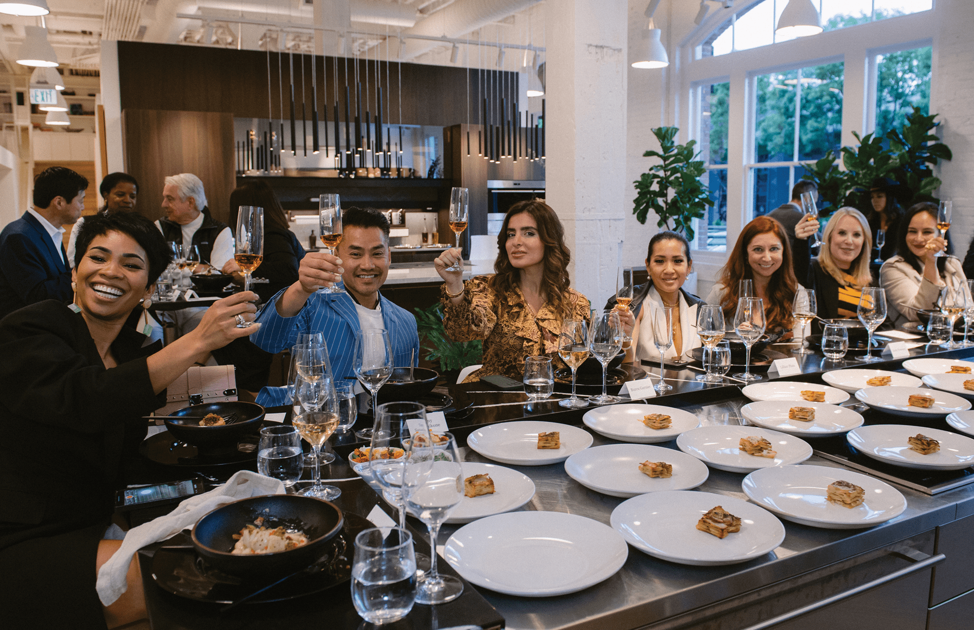 A group having dinner at the Riggs Showroom in San Francisco featuring exclusive Sub-Zero, Wolf, and Cove appliances.