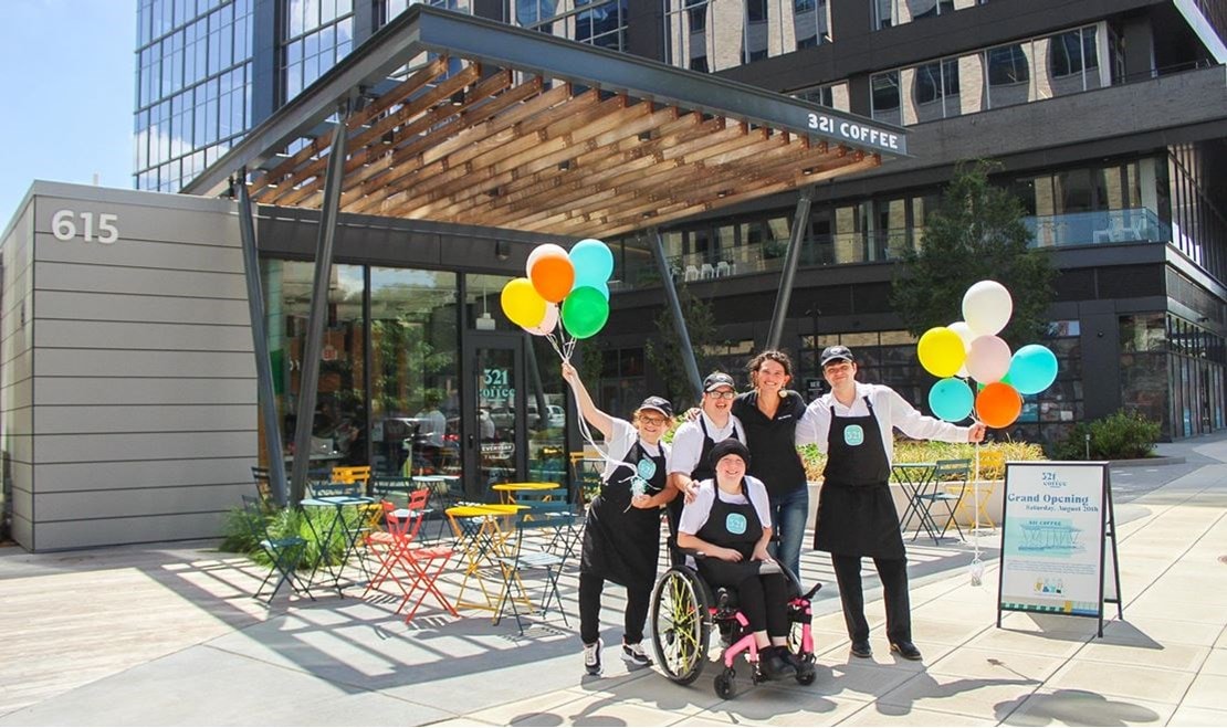 Lindsey Wrege joins some of the staff at the grand opening of 321 Coffee’s Downtown Raleigh location.