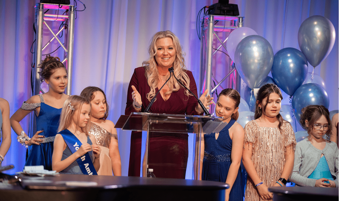 The emcee of the event, Diana Henry, speaks on stage at the event in Madison, Wisconsin.