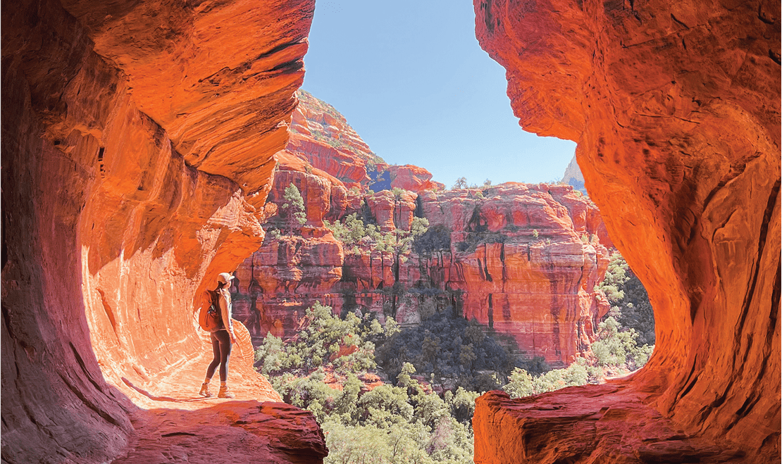 Sedona, Arizona is considered to be an energy cortex as people, like this climber, visit to see its well-known red cliffs.