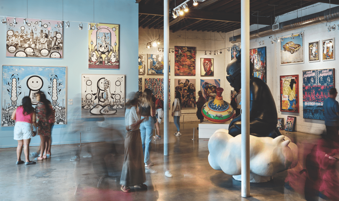 A room filled with urban art on coutless canvases.