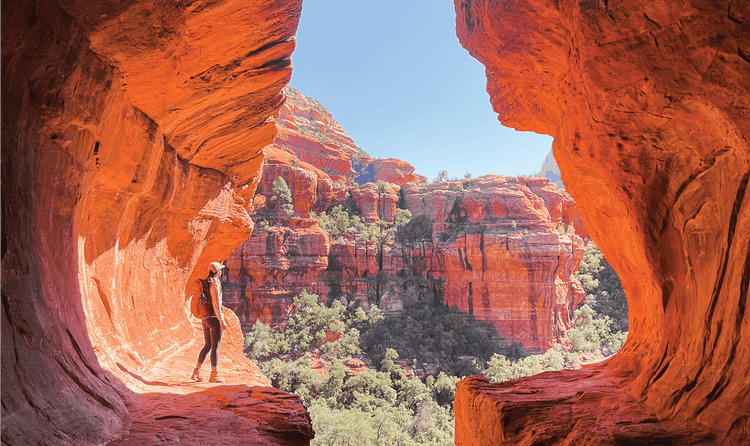 Sedona, Arizona is considered to be an energy cortex as people, like this climber, visit to see its well-known red cliffs.