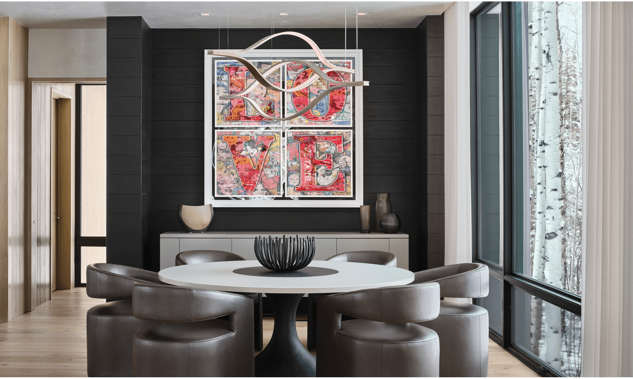 The 'LOVE' artwork pops on the wall due to the home's neutral and earthy color design.