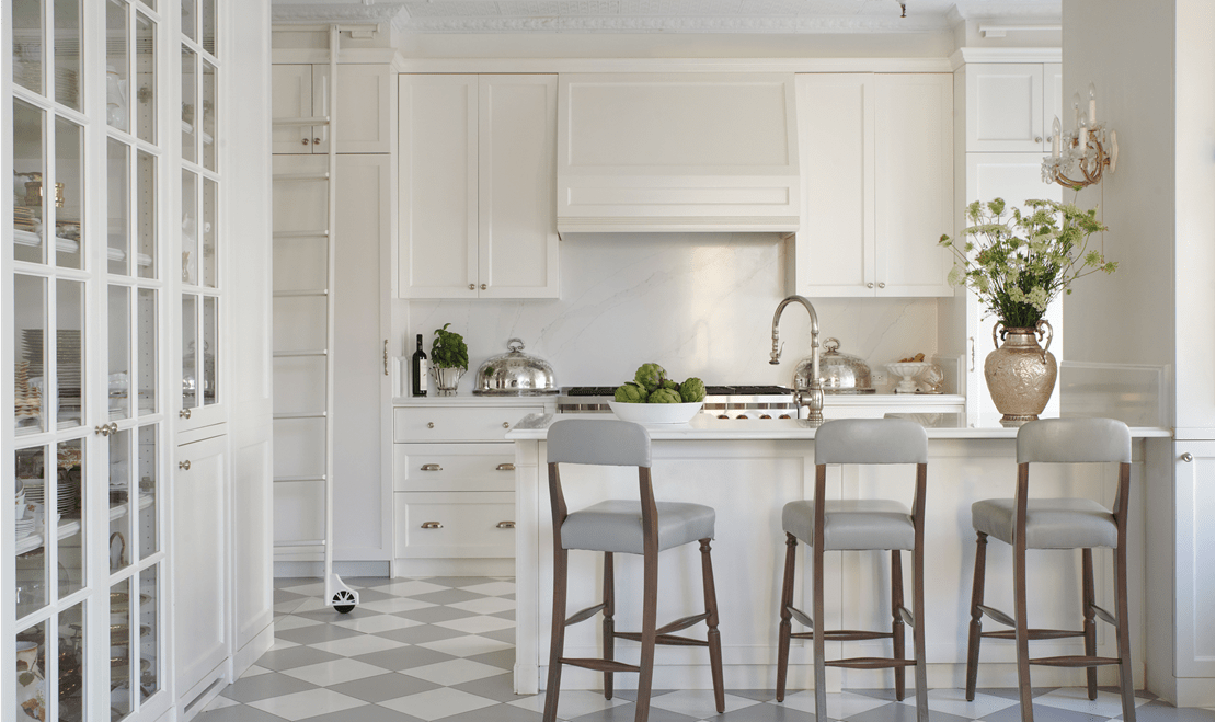 Steimburg's classic white design emphasized by the 48 inch Wolf Gas Range peeking behind the kitchen table.
