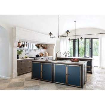 The kitchen combines simplicity and detailing, while double island hoods anchor the space.