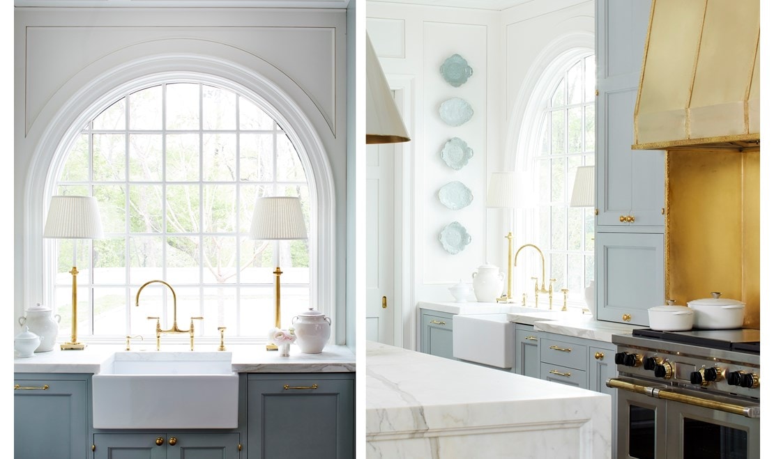 Twin table lamps frame the radius window and farmhouse sink.