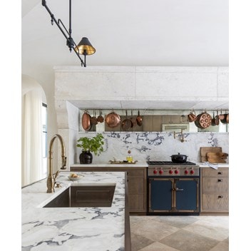 The Provençal kitchen design features a Sub-Zero refrigerator, a Wolf conventional and steam oven, and a coffee system.