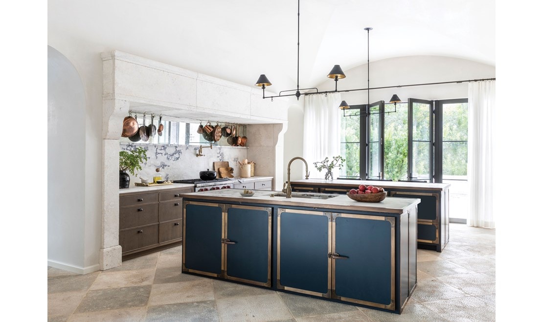 The kitchen combines simplicity and detailing, while double island hoods anchor the space.