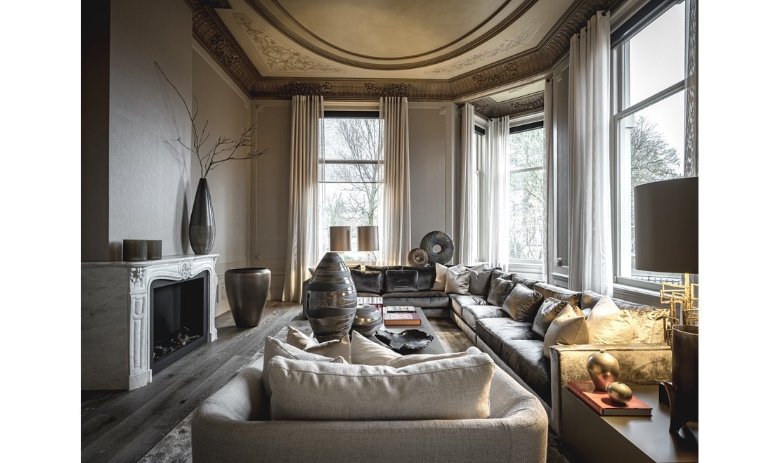 A modern fireplace warms the living space in this Dutch home.